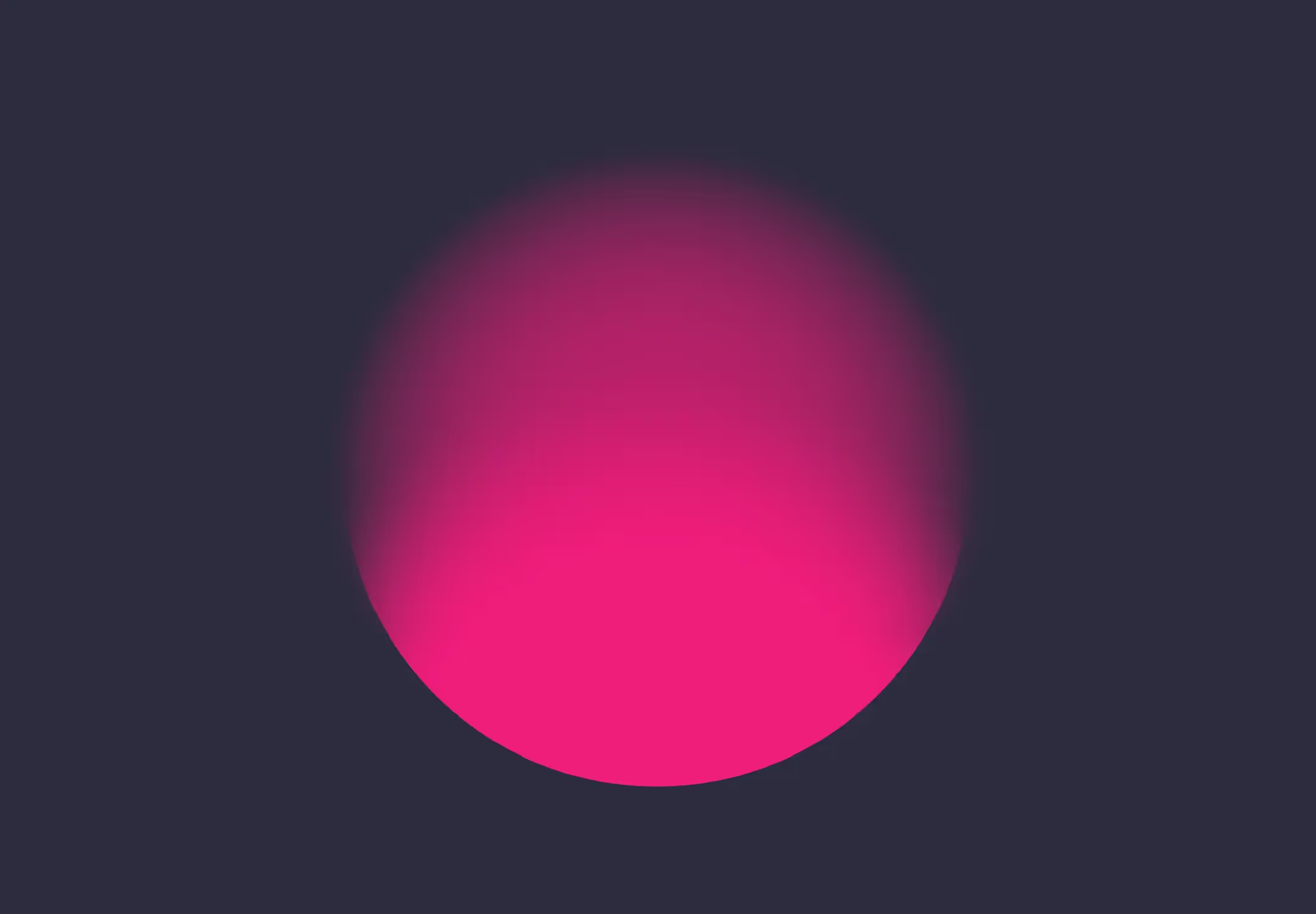 A pink cirlce on dark background. The pink cirlce appears to be half in and half out of focus